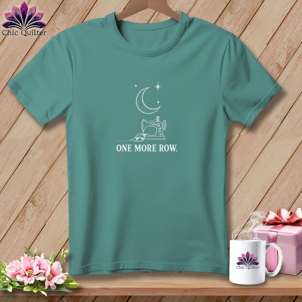 Teal t-shirt with white graphic of sewing machine, moon, stars, and text "ONE MORE ROW."