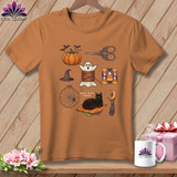 Orange t-shirt with Halloween sewing and quilting graphic featuring a pumpkin, ghost, cat, and more.