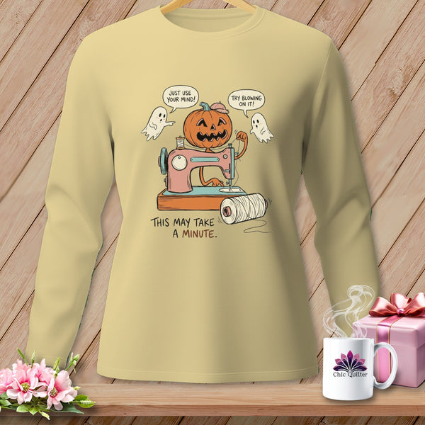 Pumpkin using a sewing machine with ghosts, text reads "Just use your mind! Try blowing on it! This may take a minute."