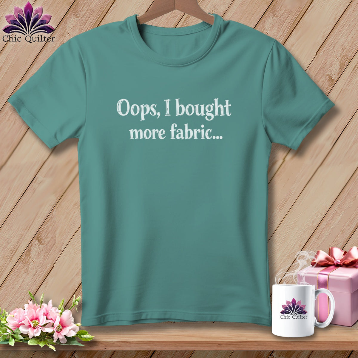 Teal t-shirt with white text "Oops, I bought more fabric..."