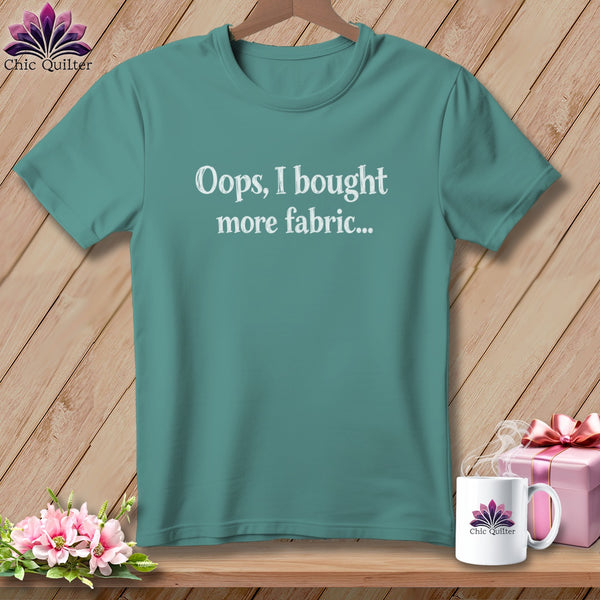 Teal t-shirt with white text "Oops, I bought more fabric..."