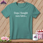 Teal t-shirt with white text "Oops, I bought more fabric..."