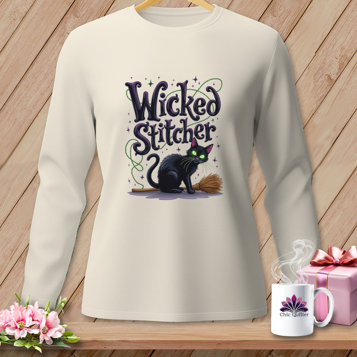 Long-sleeve shirt with "Wicked Stitcher" text, a black cat on a broom, and green bead accents.