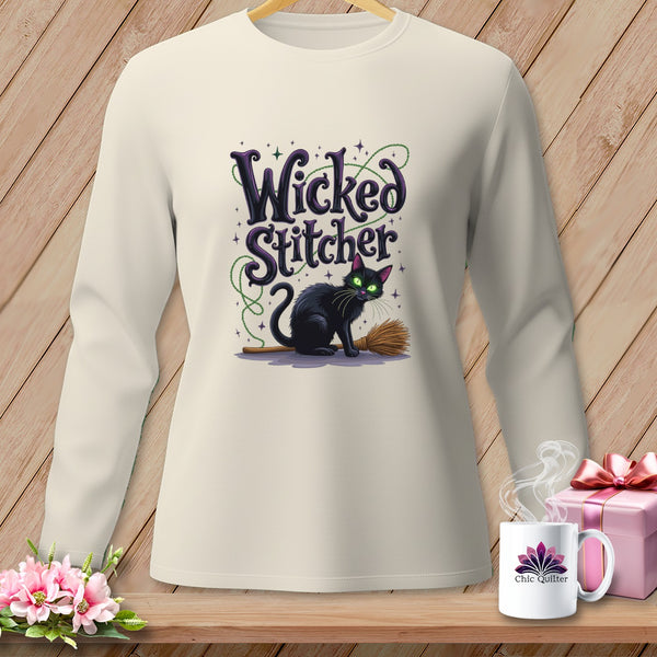 Long-sleeve shirt with "Wicked Stitcher" text, a black cat on a broom, and green bead accents.