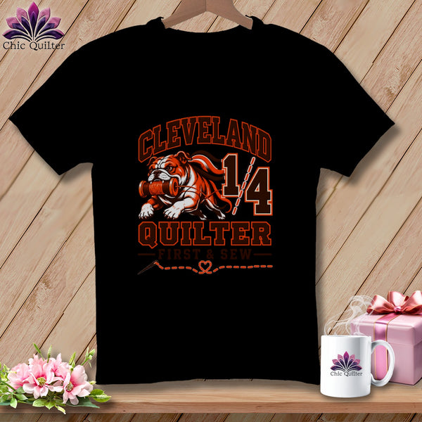 Black t-shirt featuring a Cleveland Quilter graphic with a bulldog holding a spool of thread.