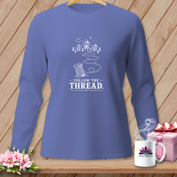 Purple long-sleeve shirt with "Follow the Thread" design and spool of thread graphic.