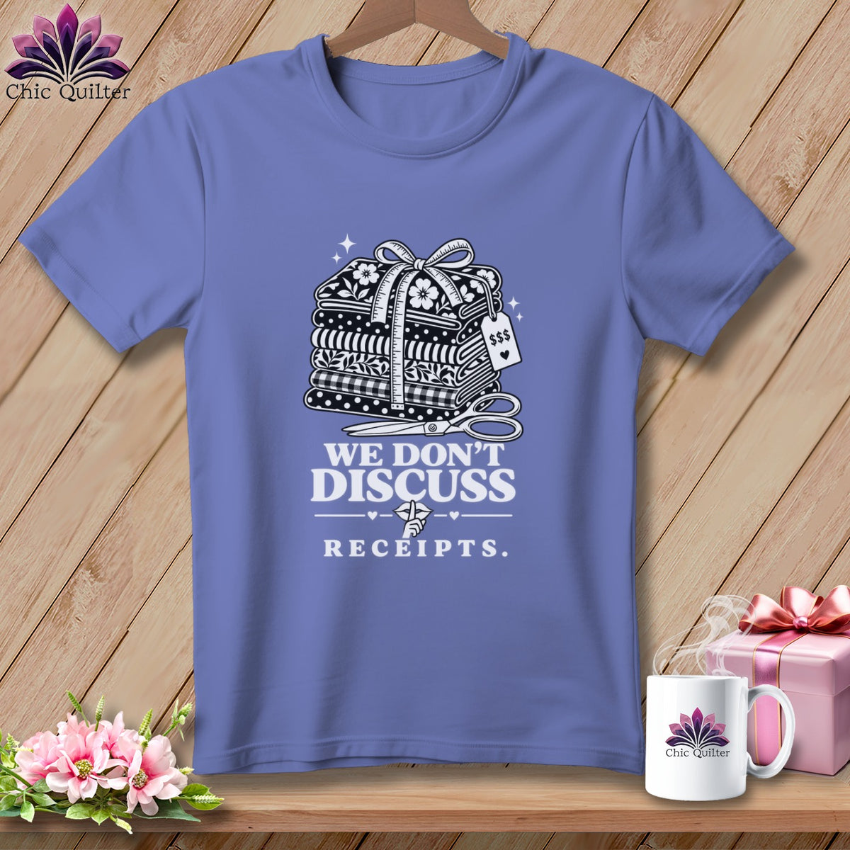Purple t-shirt with stacked fabric, sewing items, and "We Don't Discuss Receipts" text.
