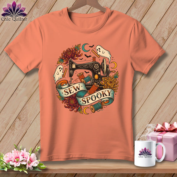 Orange t-shirt with Halloween sewing graphic: sewing machine, ghosts, bats, flowers, and "Sew Spooky" text.