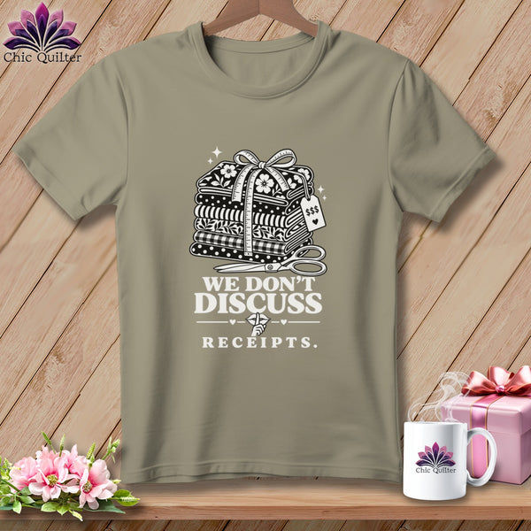T-shirt with stacked fabric, measuring tape, scissors, and text "WE DON'T DISCUSS RECEIPTS."