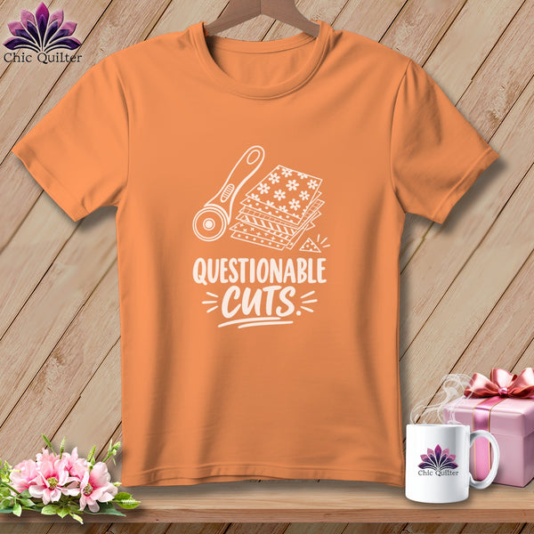 Orange t-shirt with "QUESTIONABLE CUTS" text and quilting rotary cutter graphic.