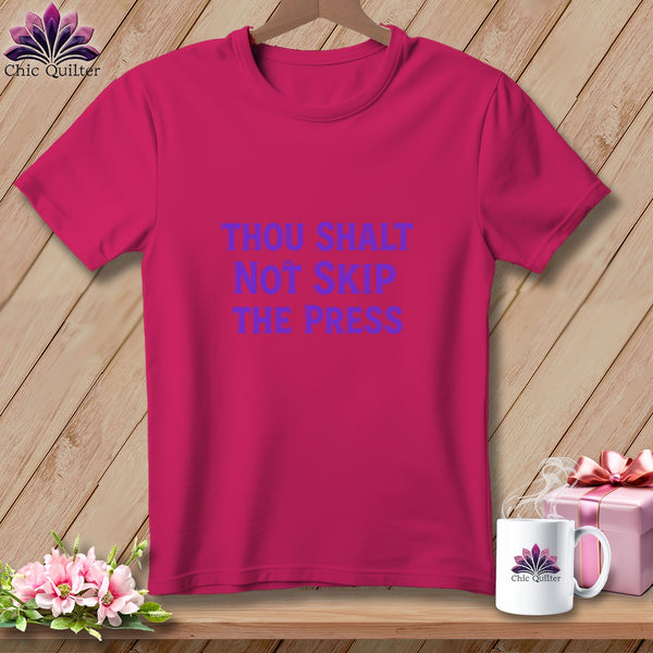 Pink t-shirt with purple text that reads "THOU SHALT NOT SKIP THE PRESS".