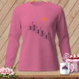 Pink long-sleeve shirt with sewing spool graphic and orange sun.