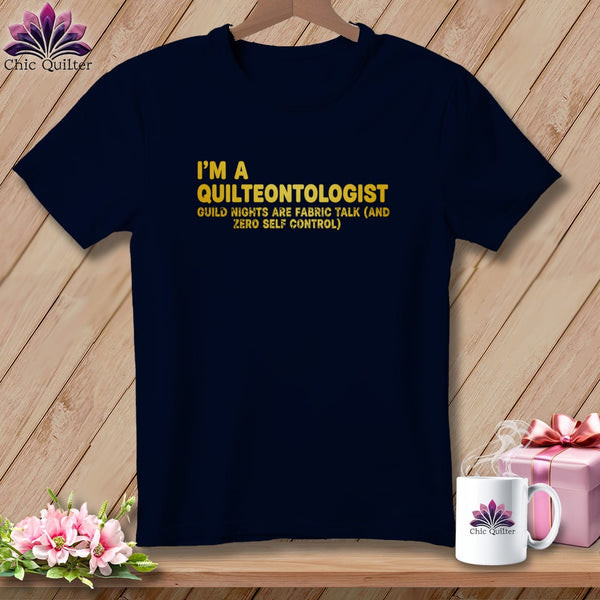 Navy t-shirt with "I'm a quilteontologist" text and floral logo.
