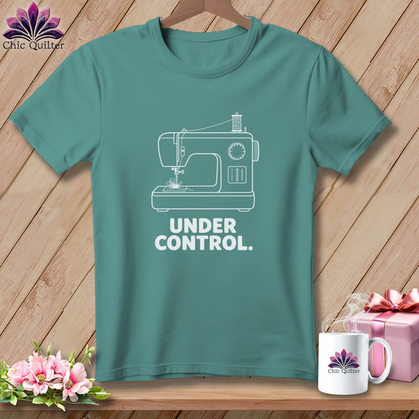 Teal t-shirt with white sewing machine graphic and "UNDER CONTROL." text.