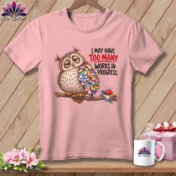 Pink t-shirt with a tired owl covered in quilt pieces and the text "I may have too many works in progress."