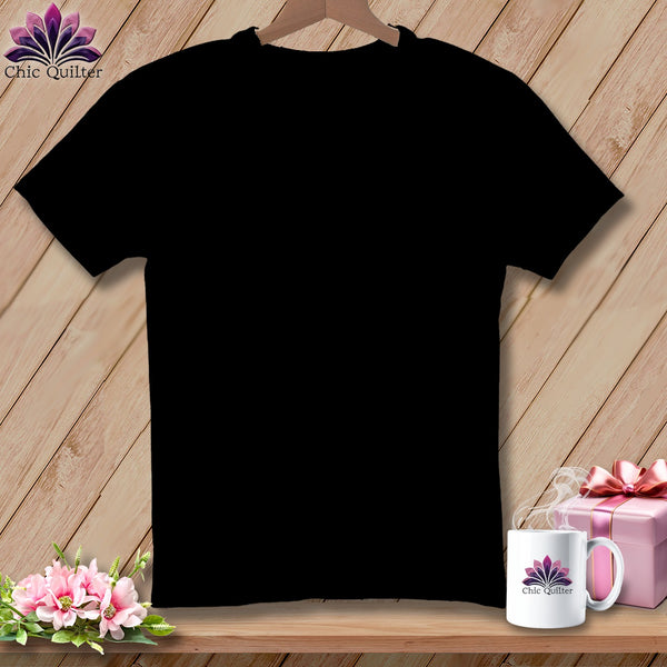 Black t-shirt with Chic Quilter logo on mug, flowers, and pink gift box.