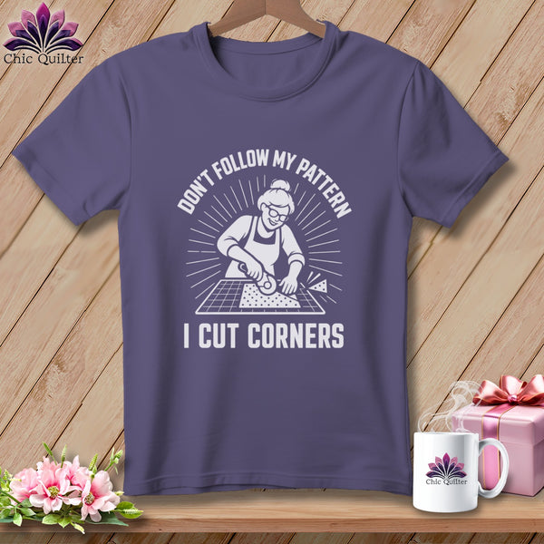 Purple t-shirt with "Don't Follow My Pattern I Cut Corners" graphic and quilting imagery.