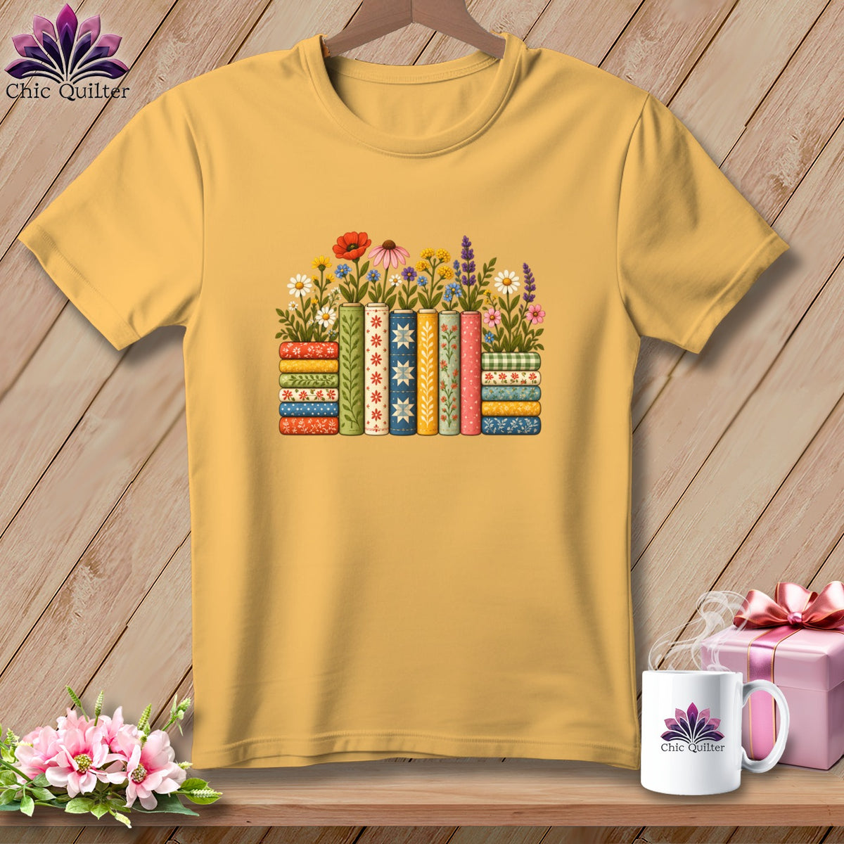 Golden yellow crewneck t-shirt featuring a stack of patterned books topped with colorful flowers.