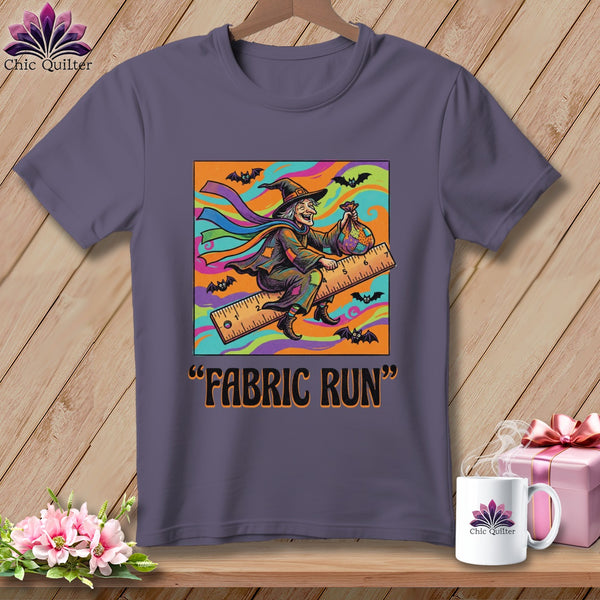 Graphic of a witch on a ruler with bats and the text "Fabric Run".