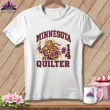 A white t-shirt features a graphic of a Viking holding a needle and spool with text reading Minnesota Quilter.