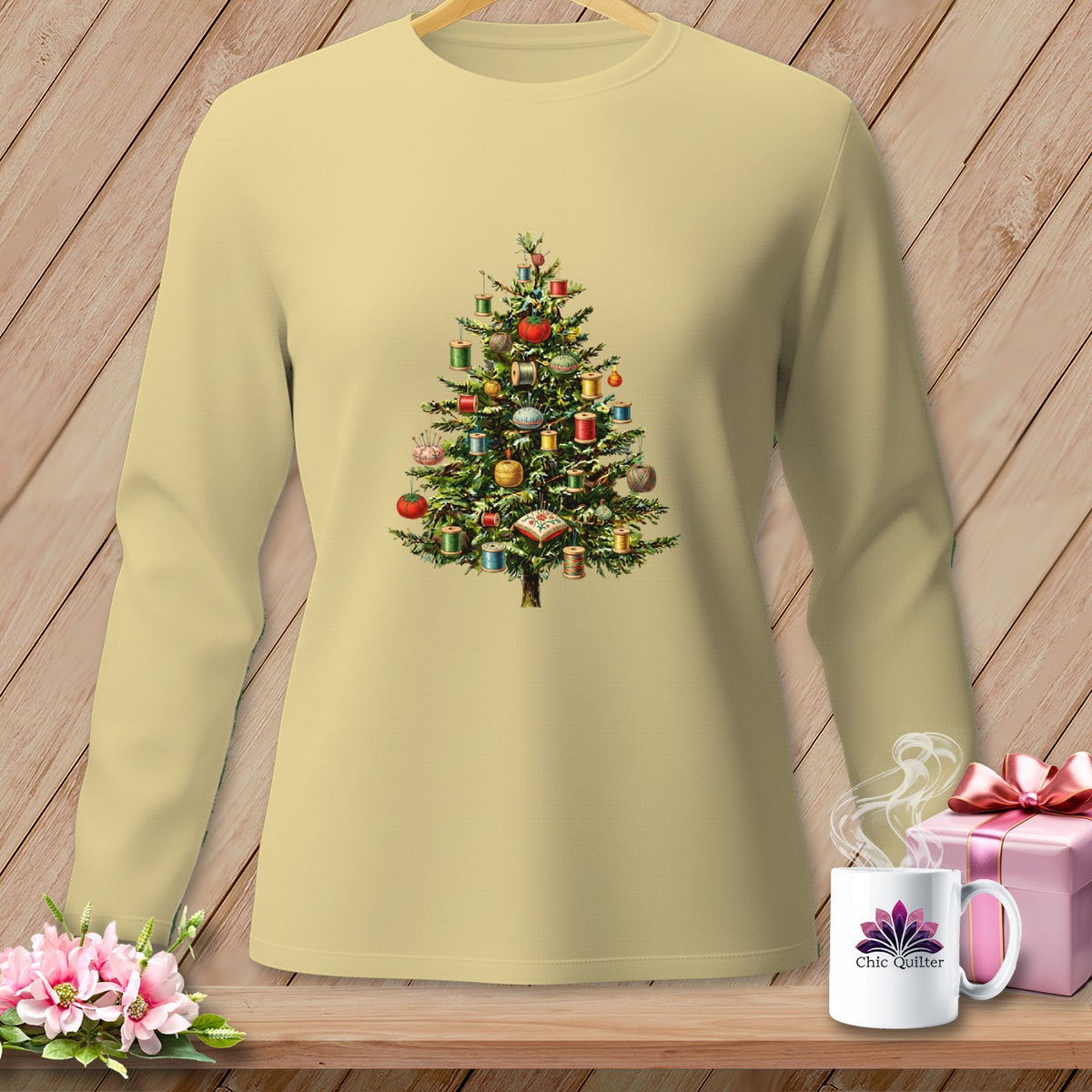 Long-sleeve cream shirt with a Christmas tree decorated with spools of thread and sewing notions.