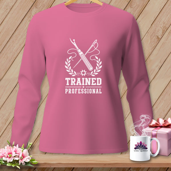 Pink long-sleeve shirt with "Trained Professional" sewing graphic and Chic Quilter mug.