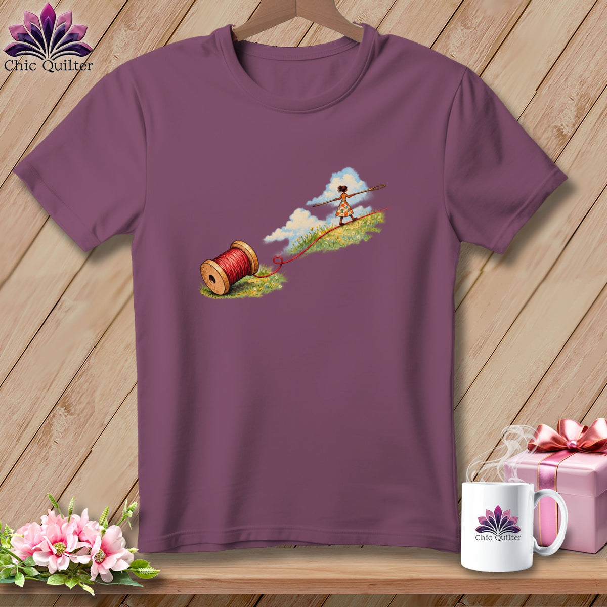 A purple t-shirt featuring a graphic of a person walking on a red thread.