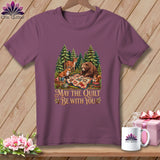 A mauve t-shirt featuring a forest graphic with woodland animals and the text 