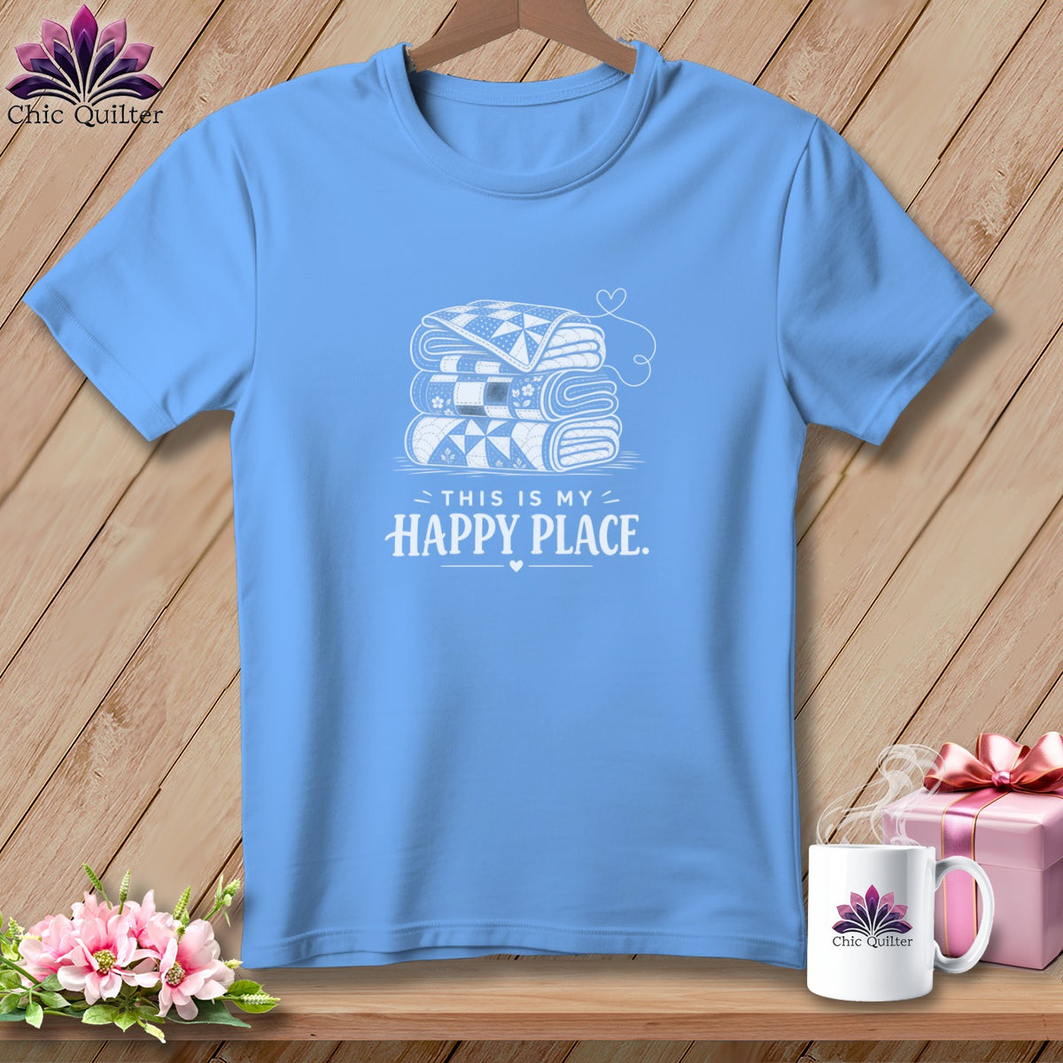 Light blue t-shirt with stacked quilts and text "THIS IS MY HAPPY PLACE."