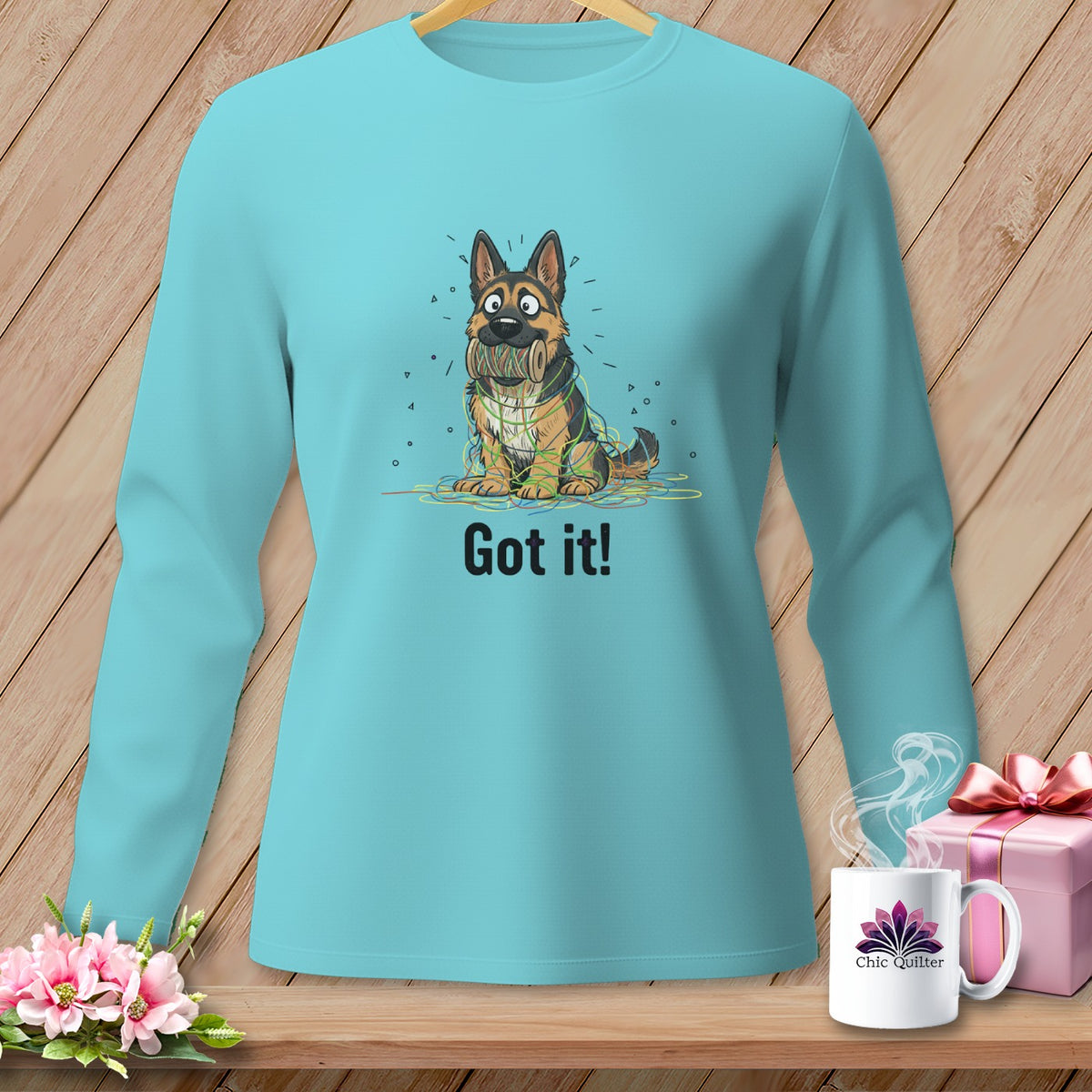 German Shepherd tangled in colorful string with "Got it!" text on teal shirt.