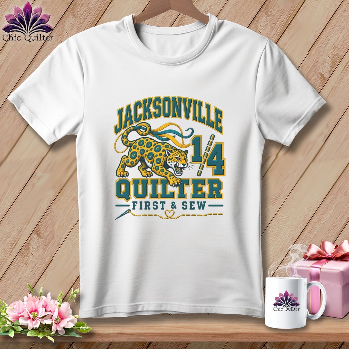 White t-shirt with a Jacksonville Quilter graphic featuring a leopard, number 14, and sewing theme.