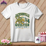 White t-shirt with a Jacksonville Quilter graphic featuring a leopard, number 14, and sewing theme.