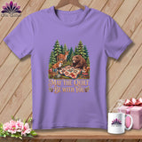 A light purple t-shirt featuring a forest scene with woodland animals and the text May the Quilt Be With You.