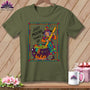 Green t-shirt with a cartoon witch stirring a cauldron with a ruler, text "JUST MIXING THINGS UP".