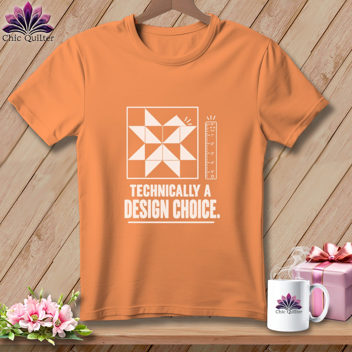 Orange t-shirt with a white quilt block design and "Technically a Design Choice" text.
