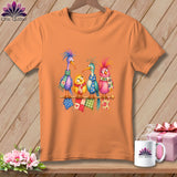 Orange t-shirt featuring an illustration of four colorful cartoon birds wearing scarves on a knitting needle.