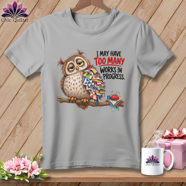 T-shirt graphic of an owl covered in quilt scraps with text "I may have TOO MANY WORKS IN PROGRESS."