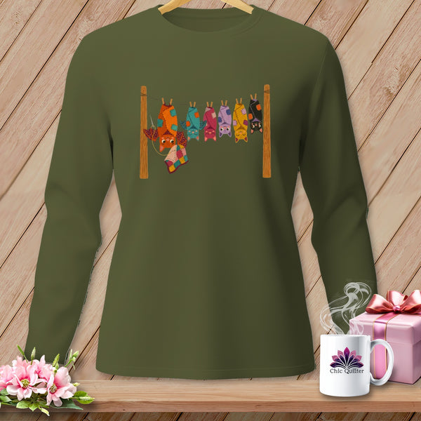 Olive green long-sleeve shirt with colorful patchwork bats hanging on a clothesline.