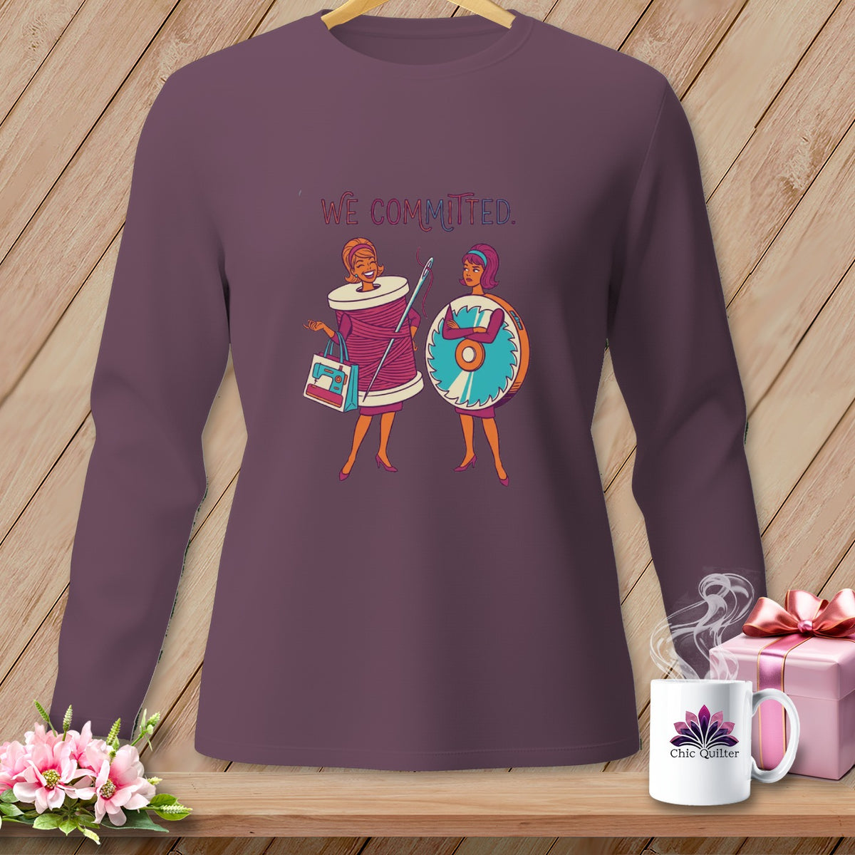 Long-sleeve shirt with "We Committed" text and sewing-themed illustrations.
