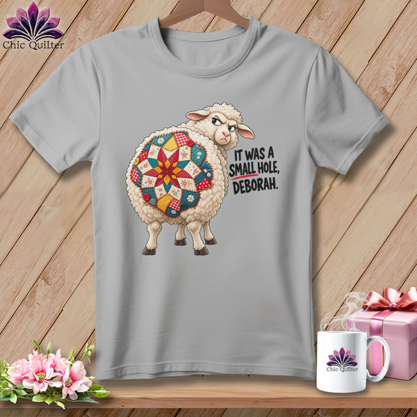 Sheep with quilt pattern on its back and text "IT WAS A SMALL HOLE, DEBORAH."