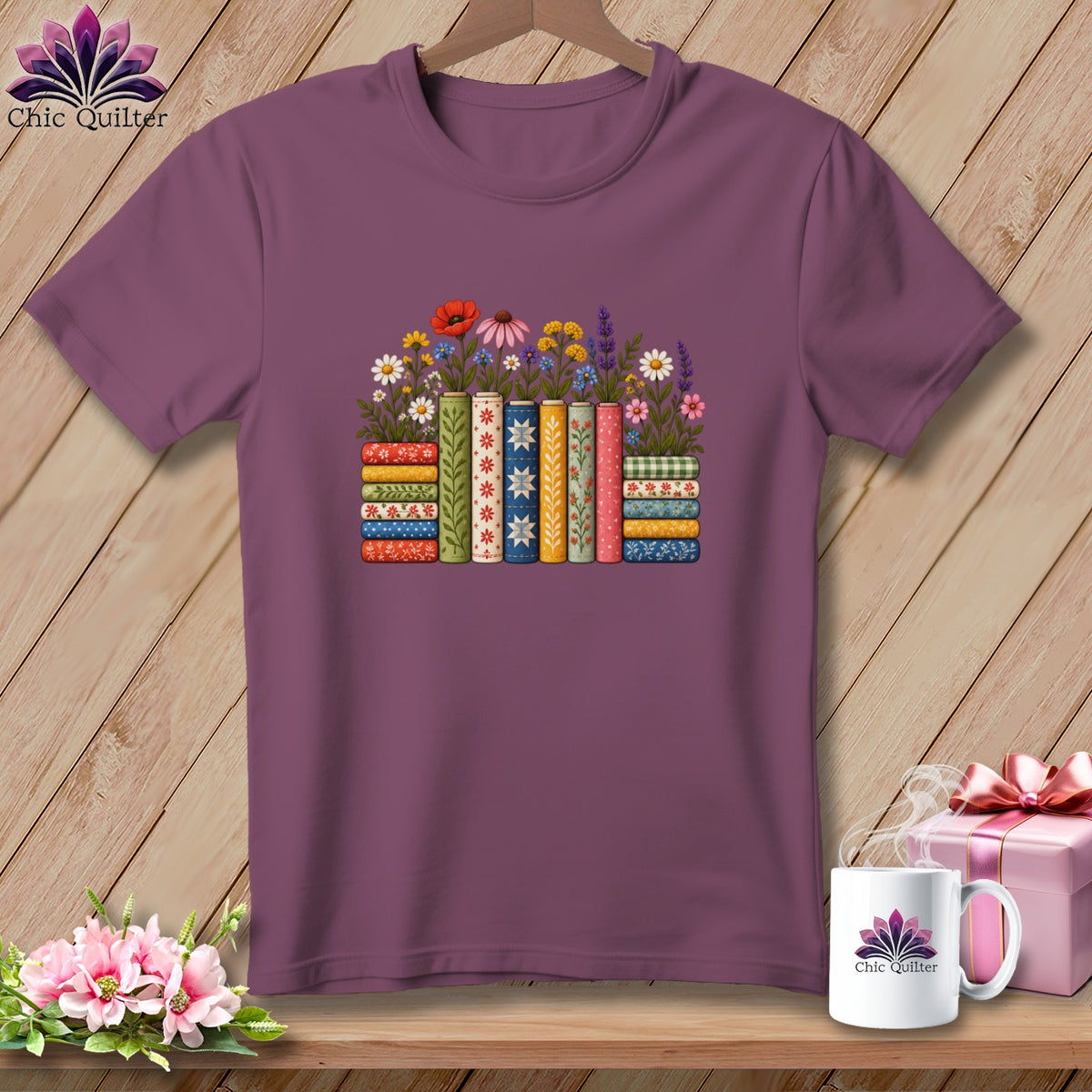 Maroon crewneck t-shirt featuring a graphic of books with colorful floral patterns and stems on a wooden background.
