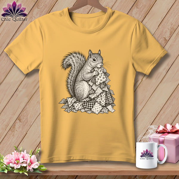 Golden yellow t-shirt featuring a black and white graphic of a squirrel sorting patterned fabric scraps.