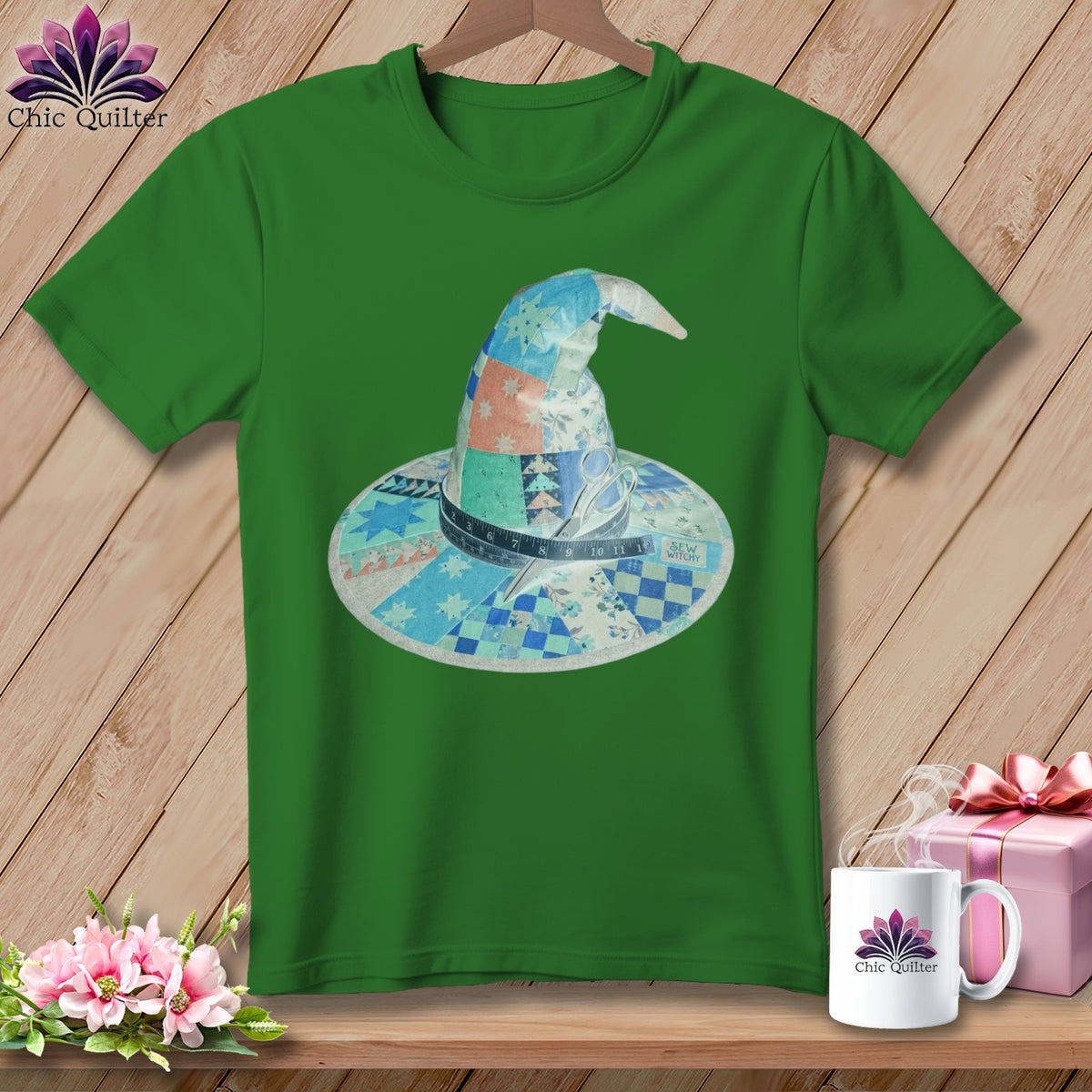 Green t-shirt with a patchwork witch hat featuring scissors and measuring tape.