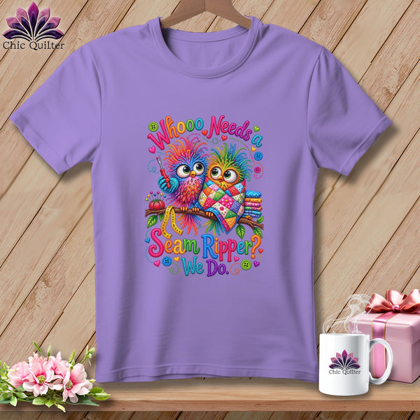 A light purple t-shirt displays a graphic of two colorful cartoon owls on a branch, with text reading Whooo Needs a Seam Ripper? We Do.