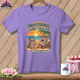 A purple crewneck t-shirt featuring a retro beach graphic with text reading professional fabric collector.