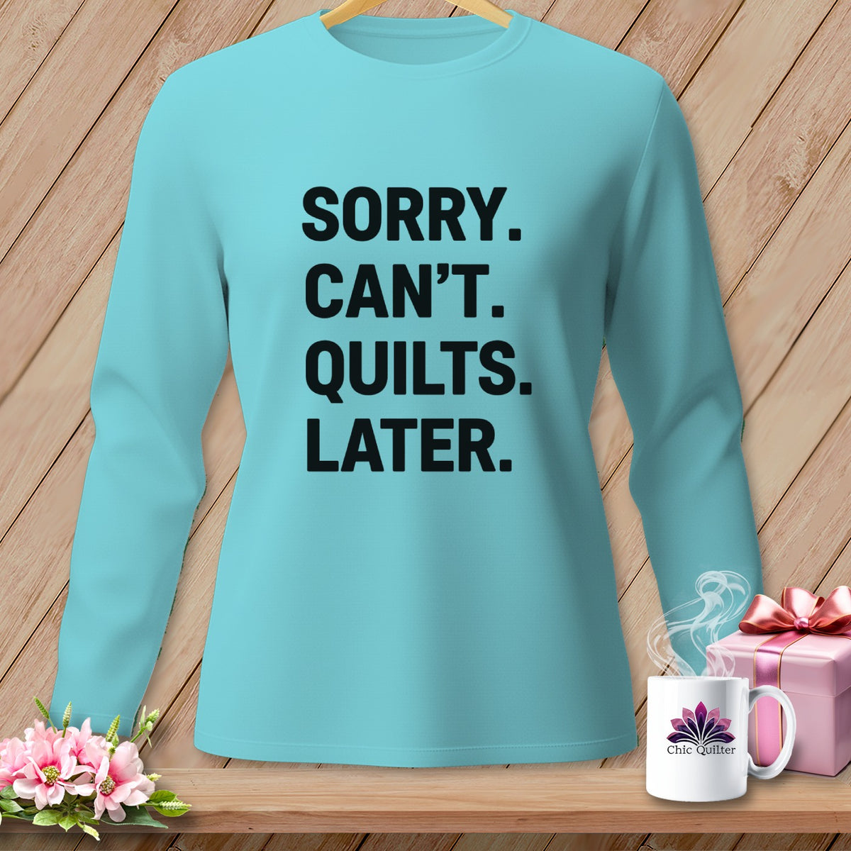 Light blue long-sleeve shirt with text "Sorry. Can't. Quilts. Later."