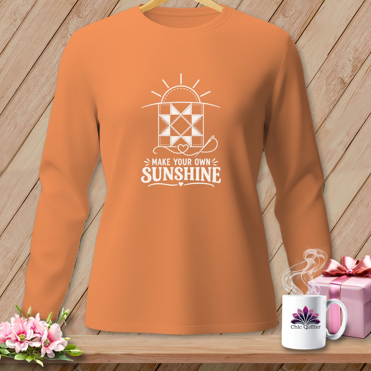 Orange long-sleeve shirt with "Make Your Own Sunshine" quilting graphic.