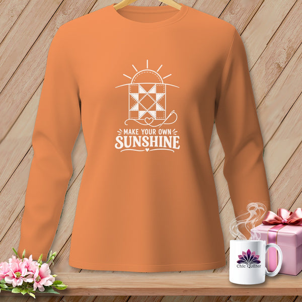 Orange long-sleeve shirt with "Make Your Own Sunshine" quilting graphic.