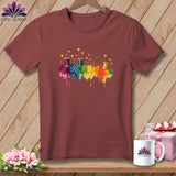 Maroon t-shirt with rainbow watercolor sewing art featuring spools, scissors, and pins.