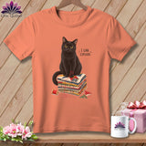 Black cat sitting on stacked fabric squares, text 